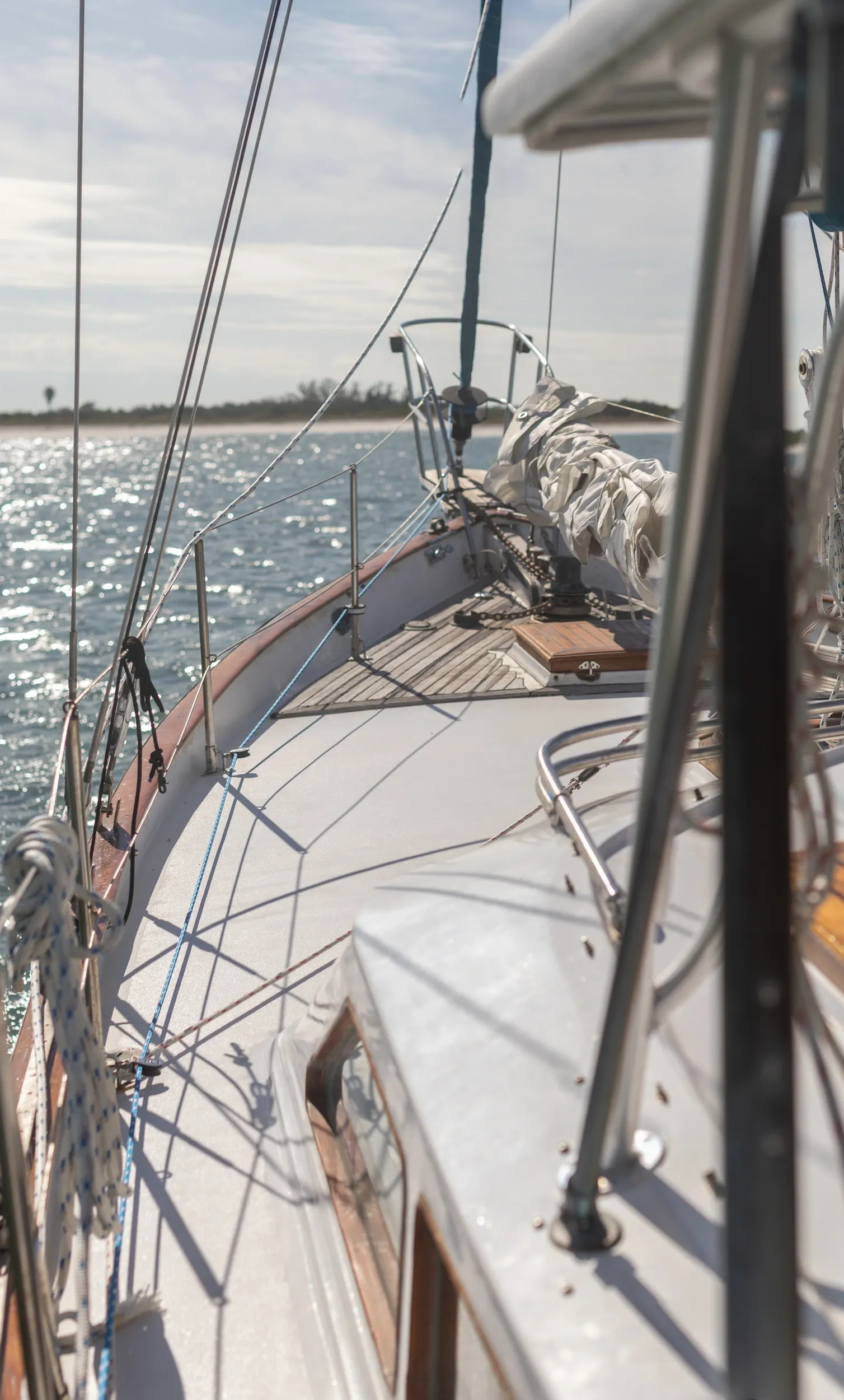 Foredeck view sailing toward barrier island
